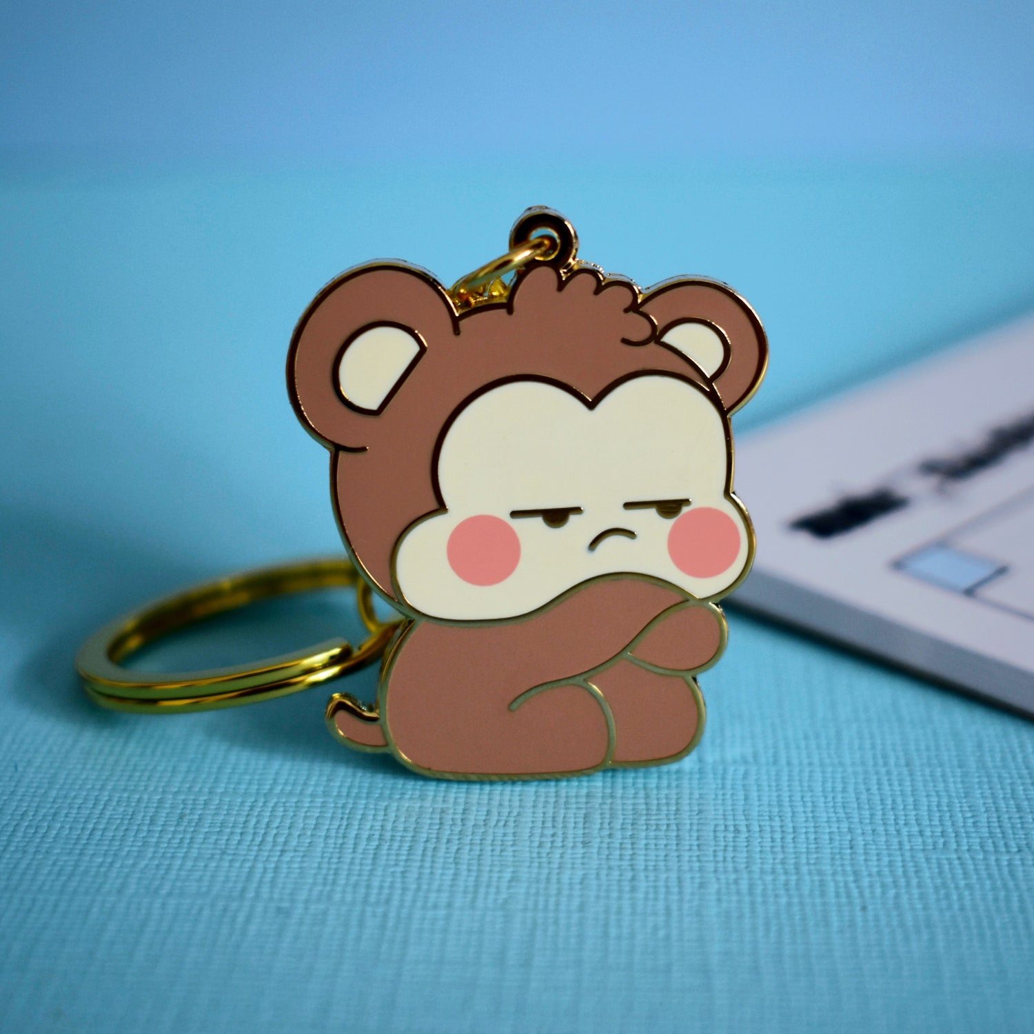 Monkey keychain on blue table