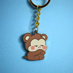 Gold monkey keychain on blue background