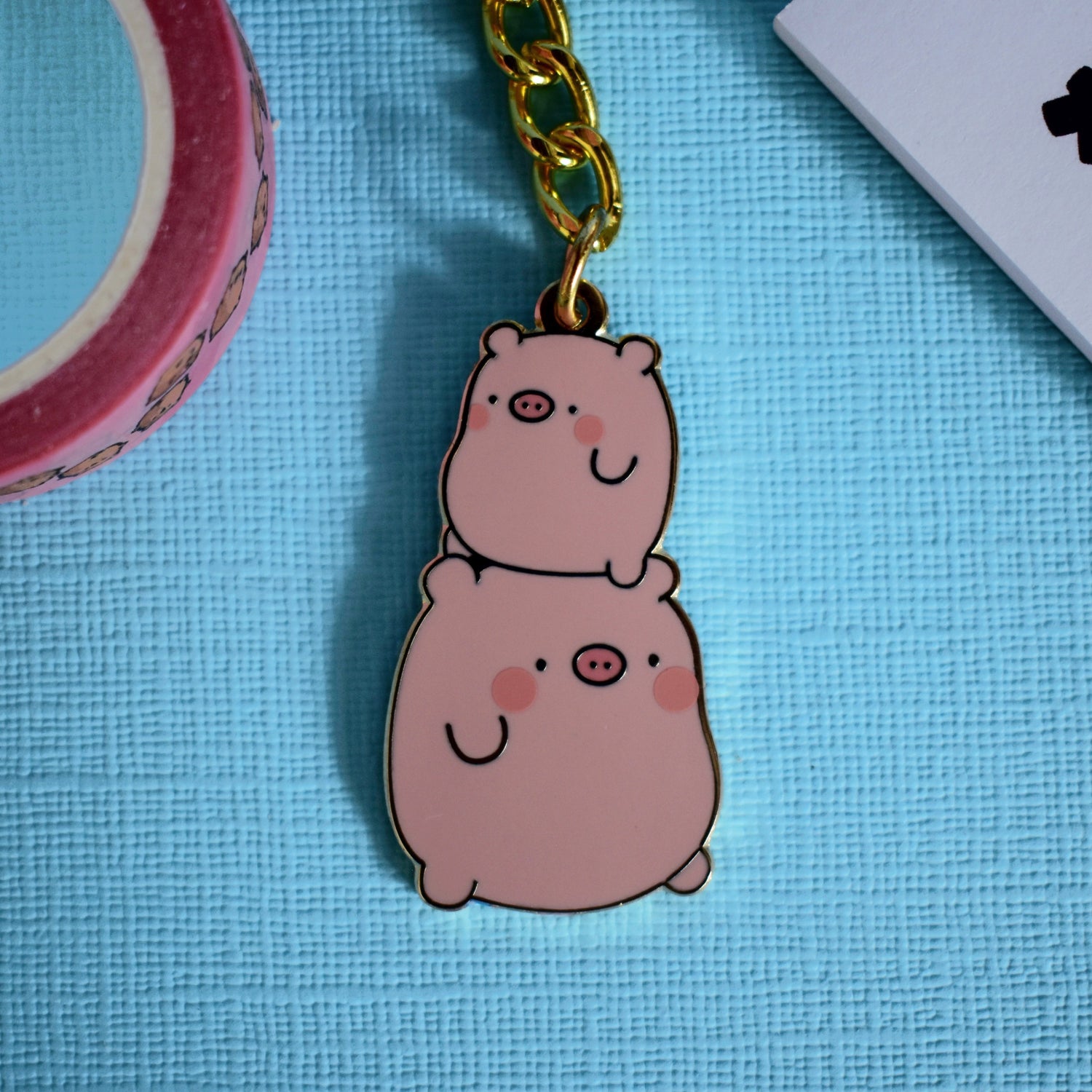 Pig keychain on blue background
