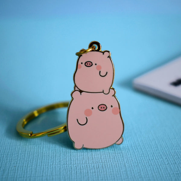 Pig keychain on blue table