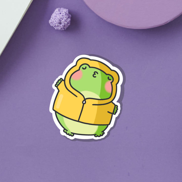 Kissing frog in hoodie vinyl sticker on purple table