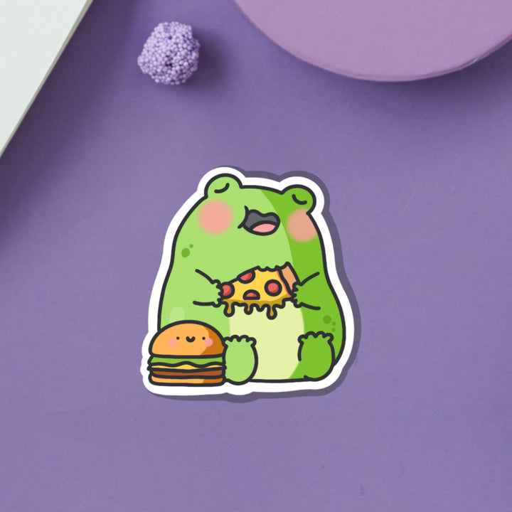 Frog eating pizza vinyl sticker on purple table