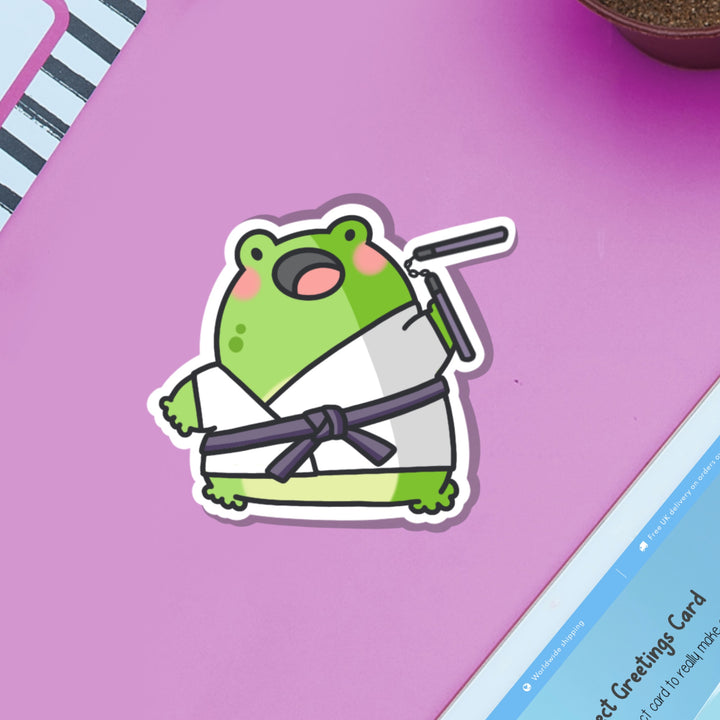 Karate frog vinyl sticker on purple table and ipad