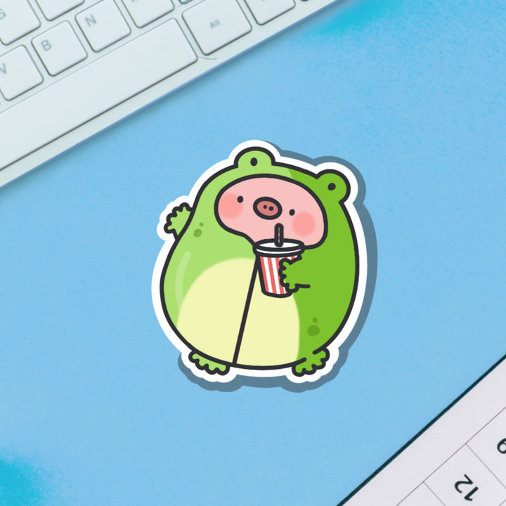 Pig in Frog Outfit Vinyl sticker on blue background