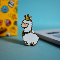 Llama wearing crown enamel pin with blue background
