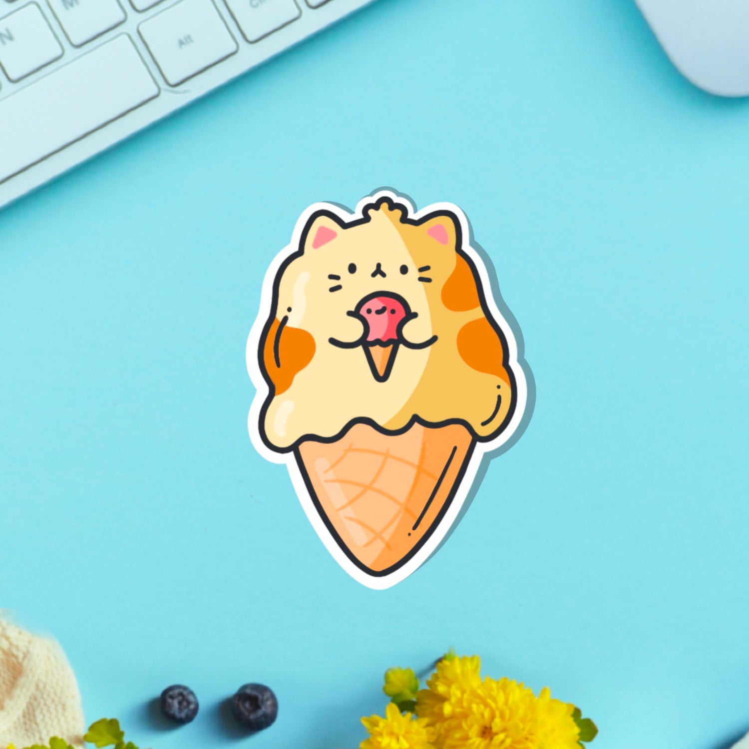 cat as ice cream vinyl sticker on blue table with keyboard