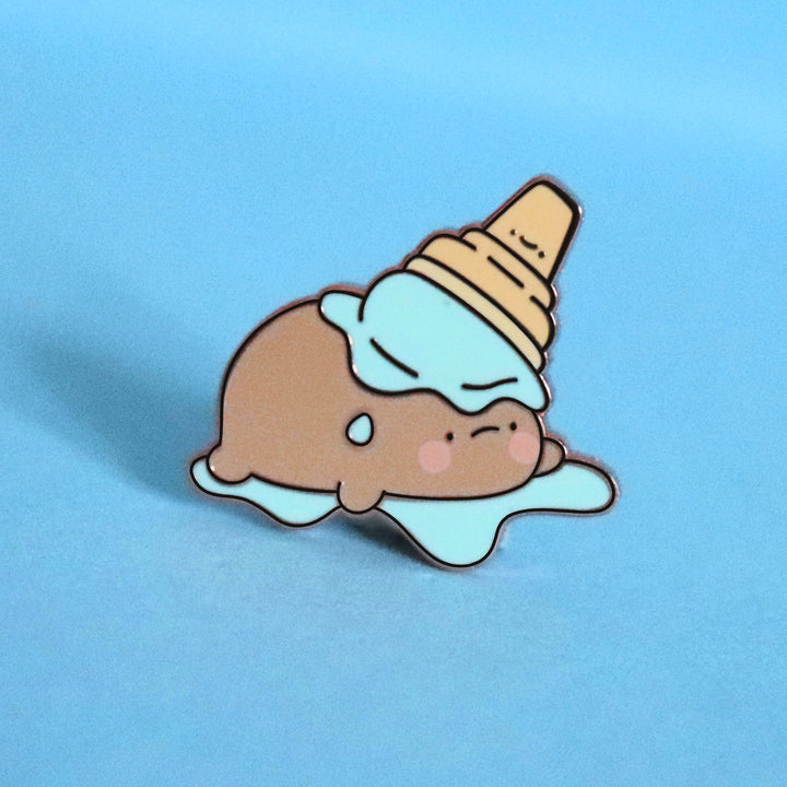 Potato in ice cream enamel pin on blue table