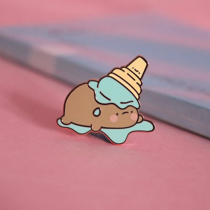 Potato in ice cream enamel pin on pink table with notepad