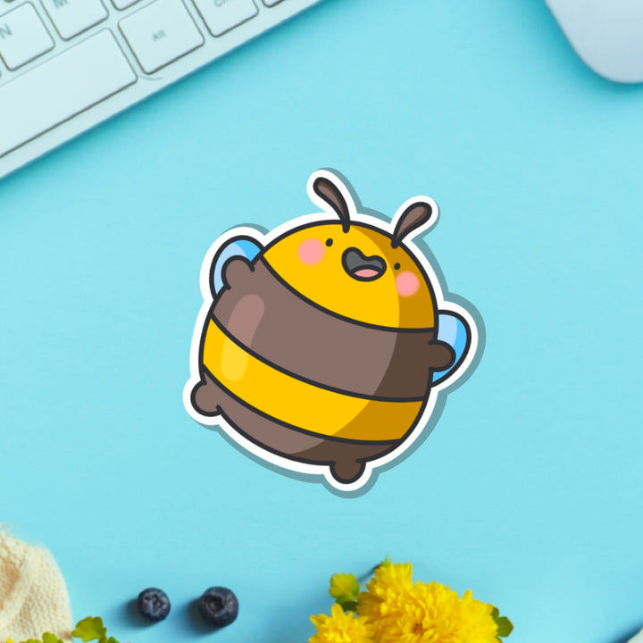 Jumping bee vinyl sticker on blue table with keyboard