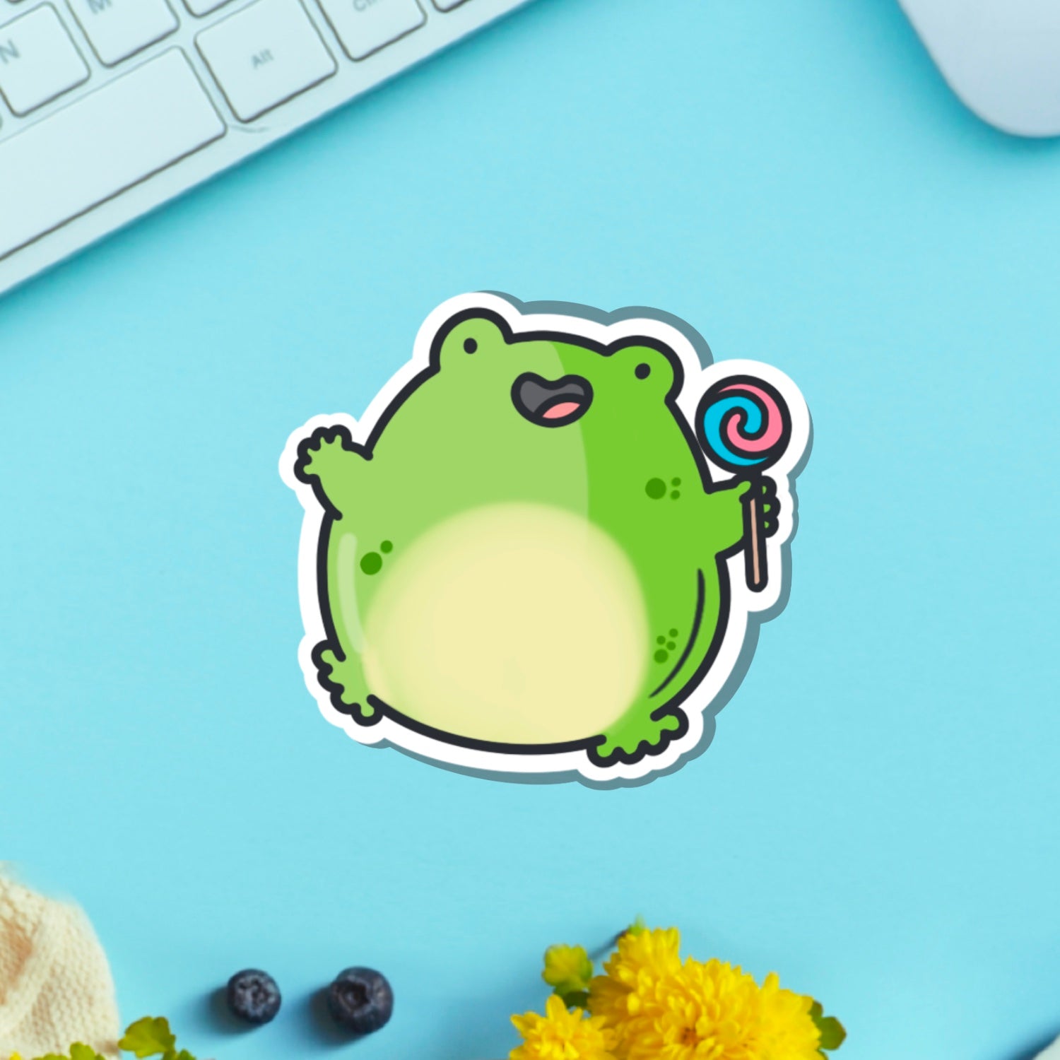 Jumping frog vinyl sticker on blue table with keyboard