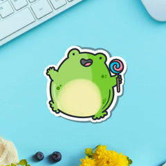 Jumping frog vinyl sticker on blue table with keyboard