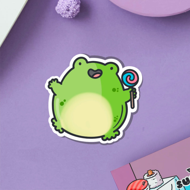 Jumping frog vinyl sticker on purple table