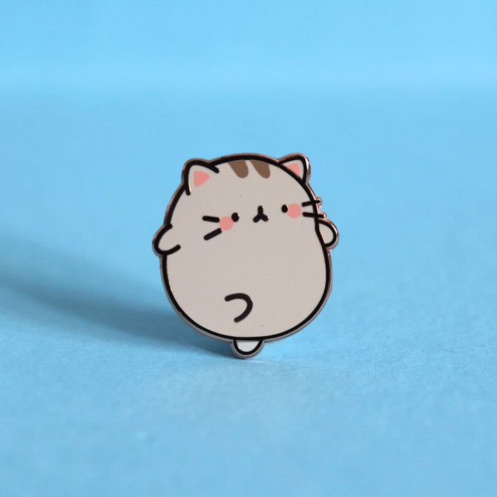 Grey Kitty Cat Enamel Pin on blue desk