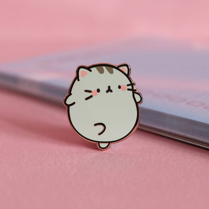 Grey Kitty Cat Enamel Pin on pink desk with notepad