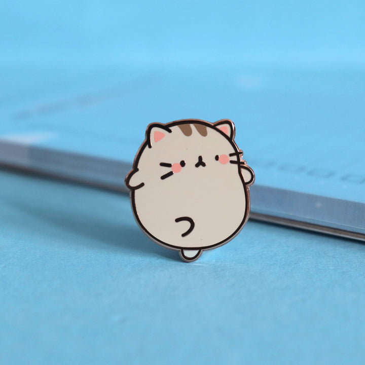 Grey Kitty Cat Enamel Pin on blue table