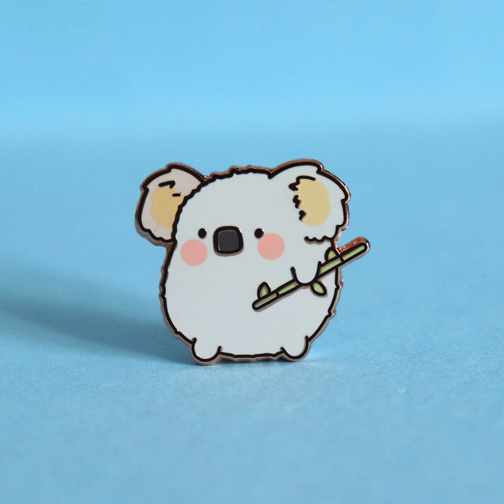 Koala enamel pin on blue desk