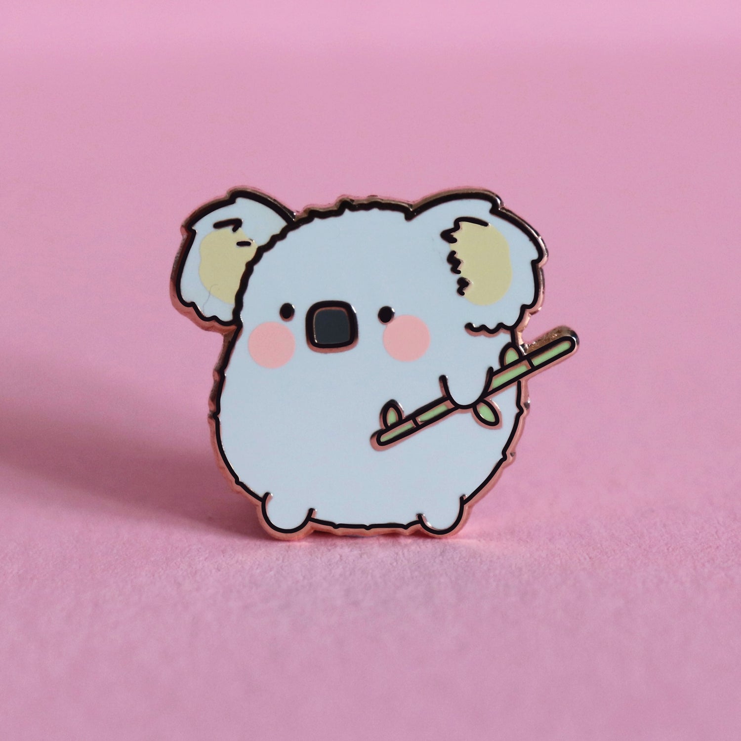 Koala enamel pin on pink table