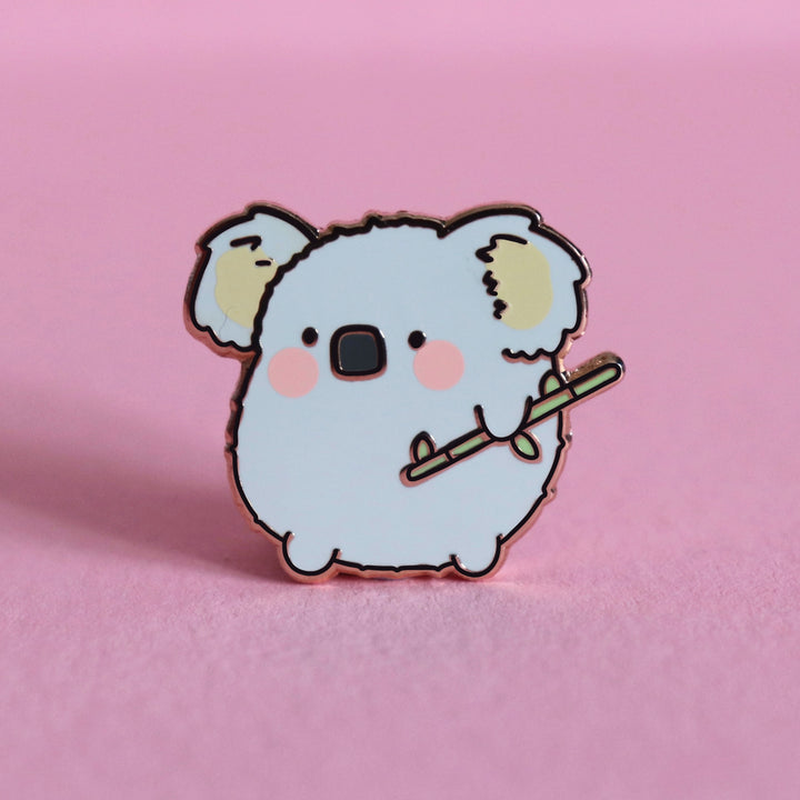 Koala enamel pin on pink table