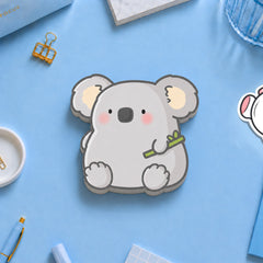 Koala shaped die cut sticky notes on blue desk