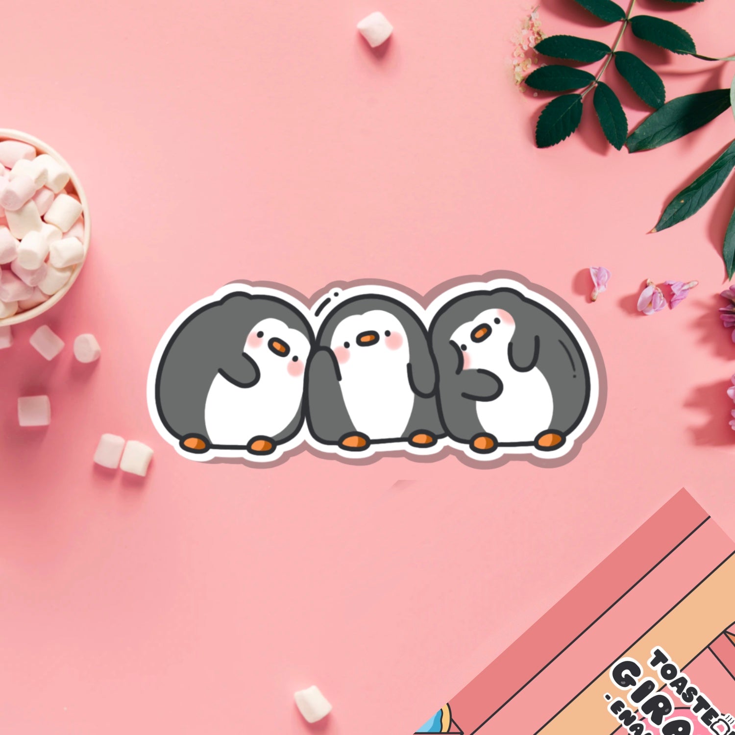 Line of penguins vinyl sticker on pink table