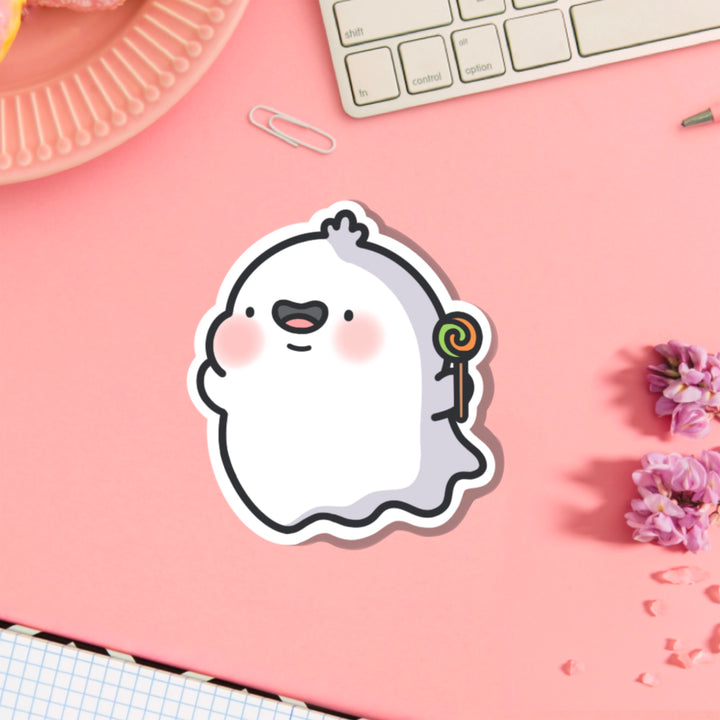 Ghost holding lollipop vinyl sticker on pink table