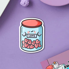 Love jar vinyl sticker on purple table