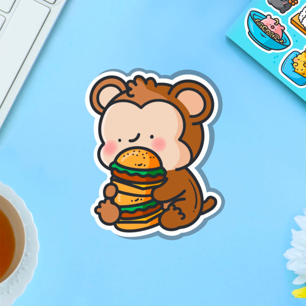 Monkey eating burgers vinyl sticker on blue table