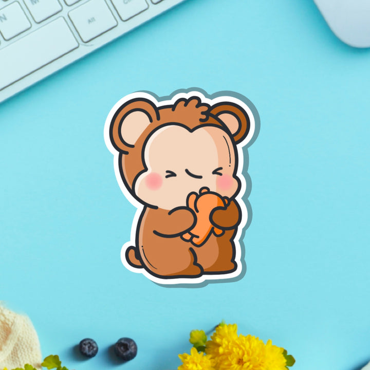 Monkey hugging teddy bear vinyl sticker on green table