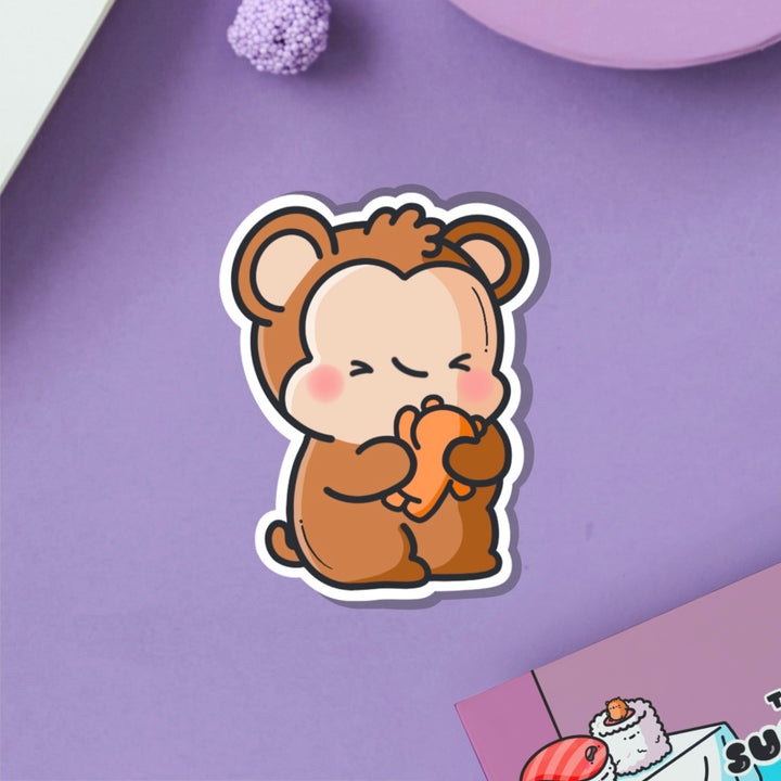 Monkey hugging teddy bear vinyl sticker on purple table