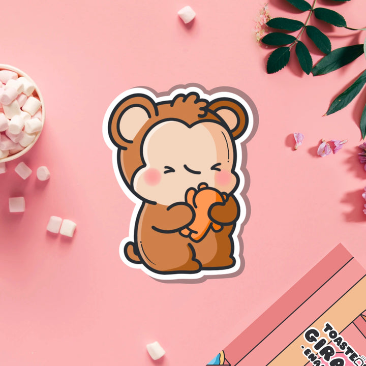 Monkey hugging teddy bear vinyl sticker on pink table