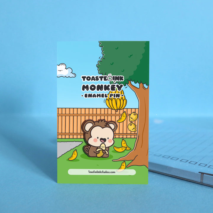 Monkey enamel pin on backing card