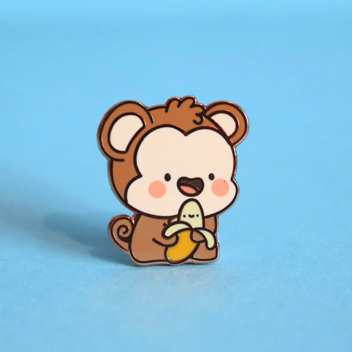 Monkey enamel pin on blue background