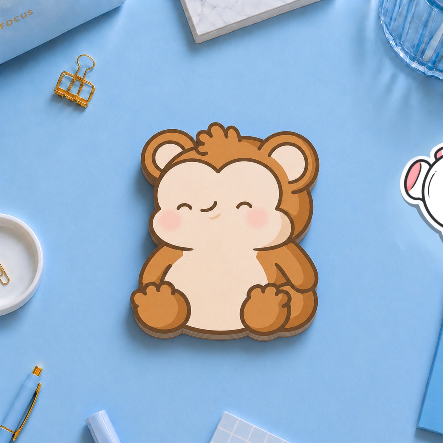 monkey shaped sticky notes on blue table with stationery
