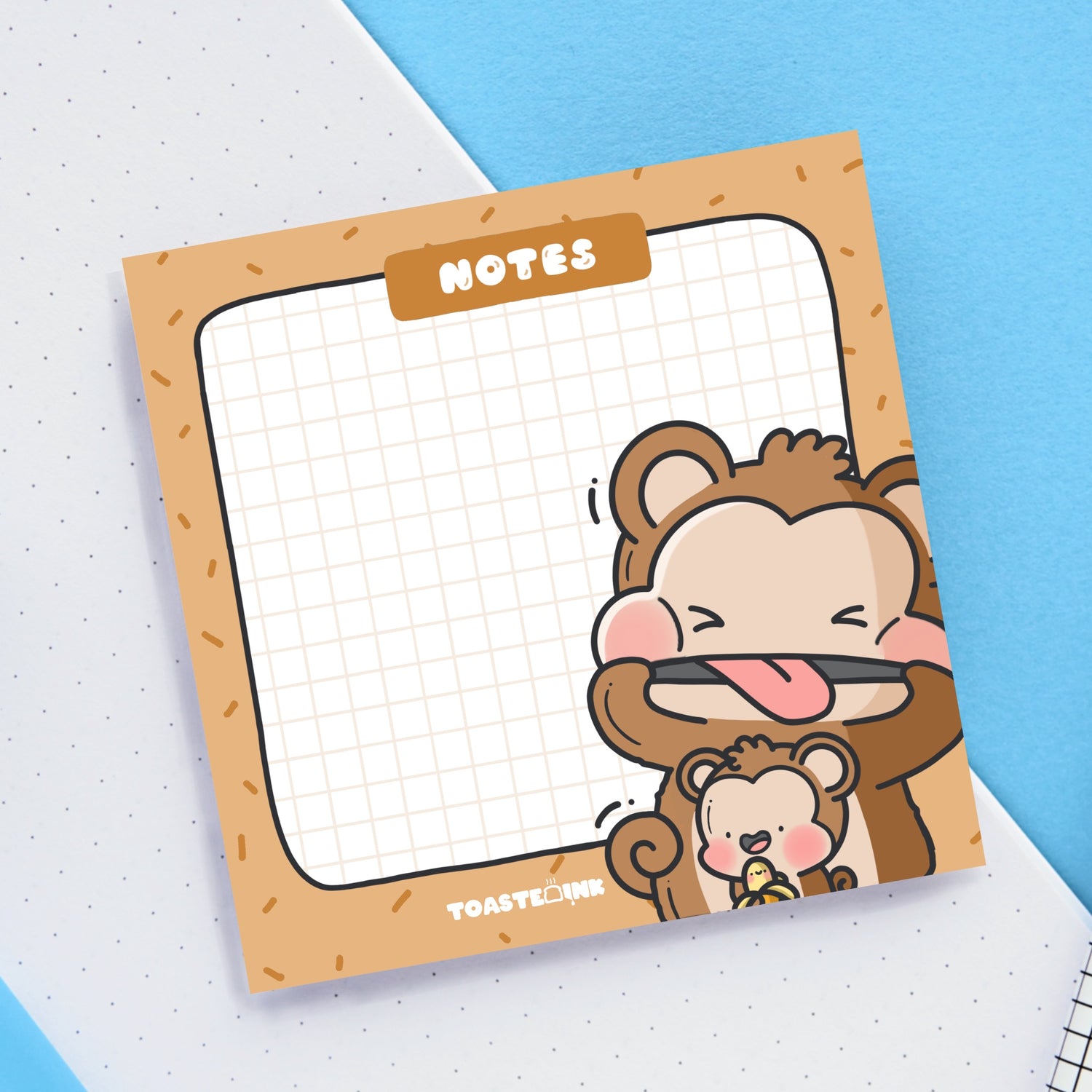 Monkey sticky notes on blue and white desk