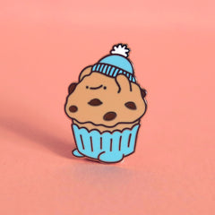 Muffin enamel pin on pink desk