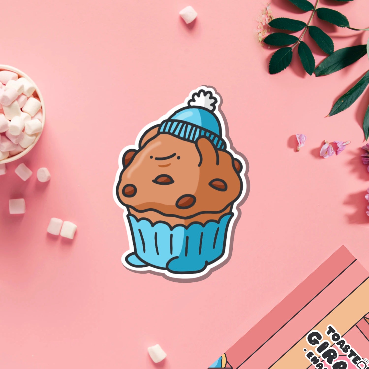 Muffin wearing hat vinyl sticker on pink table