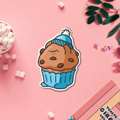 Muffin wearing hat vinyl sticker on pink table