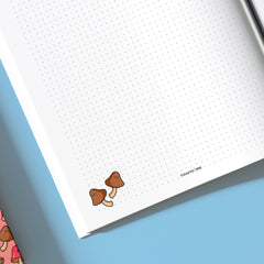 Close up mushroom on dot grid notebbok