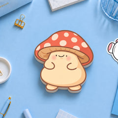 Mushroom sticky notes on blue table with stationery pieces