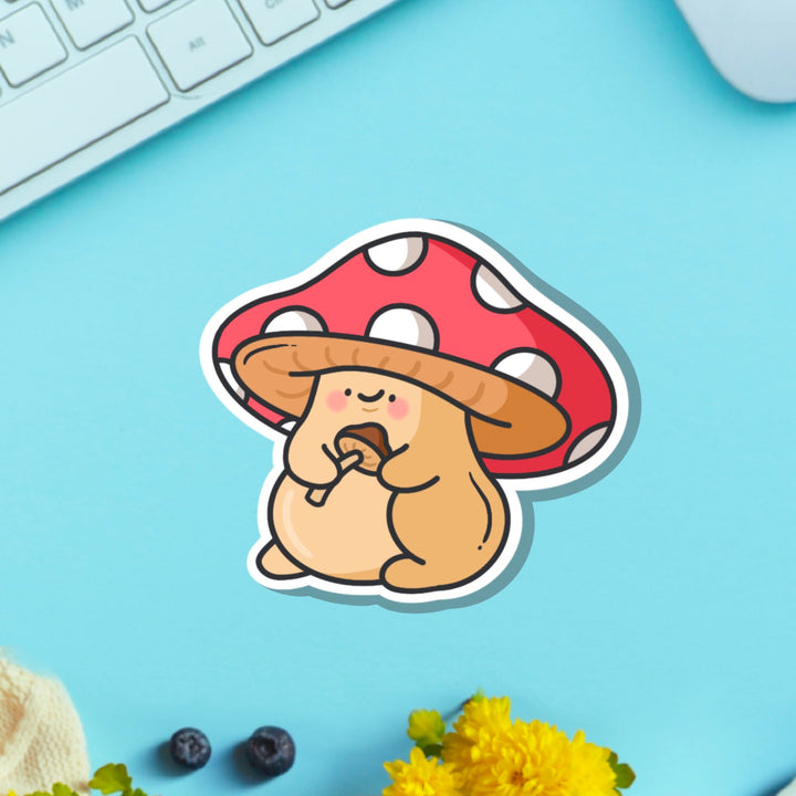 Mushroom vinyl sticker on blue table with keyboard