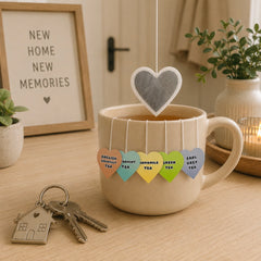 Heart shaped tea bags over a mug with different flavour tags 