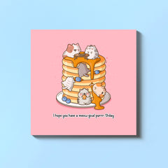 Cat with pancakes greetings card on blue table