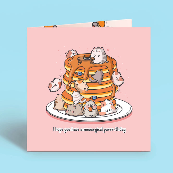 Cats on pancakes birthday card on blue table