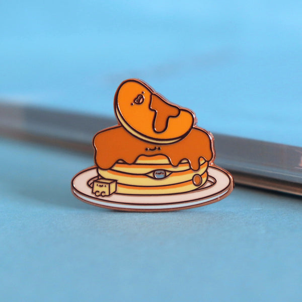 Pancakes enamel pin on blue table with notepad