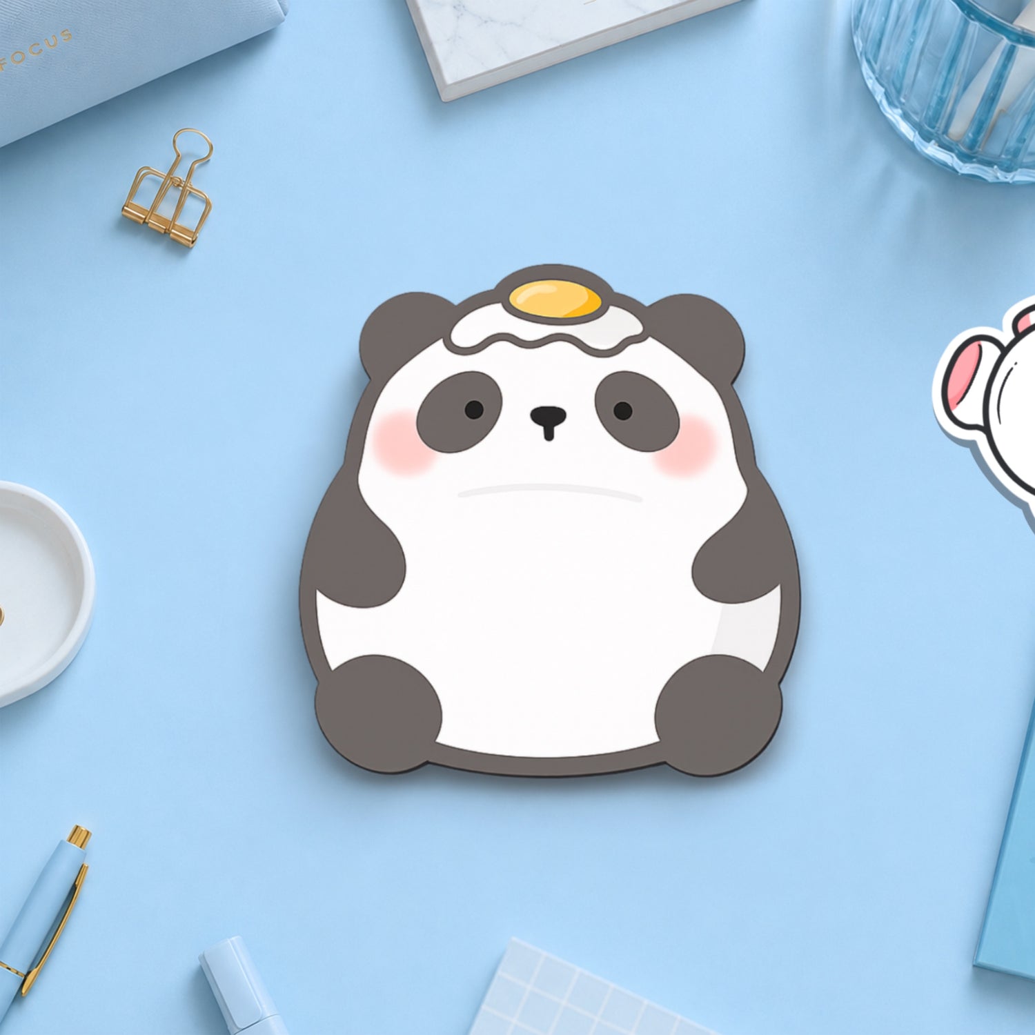 Panda with egg on his head sticky notes on blue desk