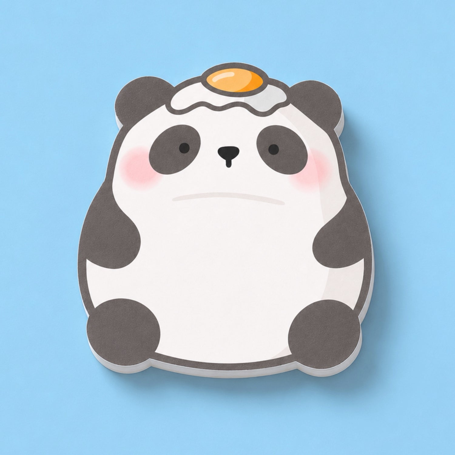A cute panda-shaped sticky notes with a fried egg on its head, shown on a solid light blue background.