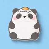 A cute panda-shaped sticky notes with a fried egg on its head, shown on a solid light blue background.
