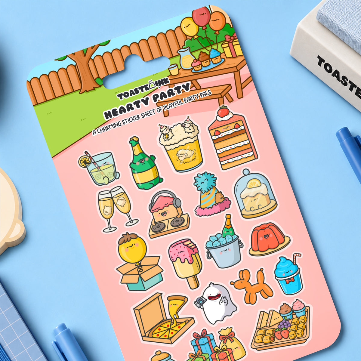 Party sticker sheet on blue desk with stationery