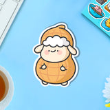 Sheep dressed as peanut vinyl sticker on blue table