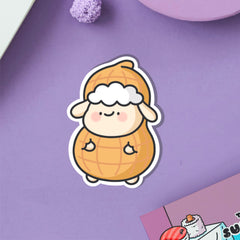 Sheep dressed as peanut vinyl sticker on purple table